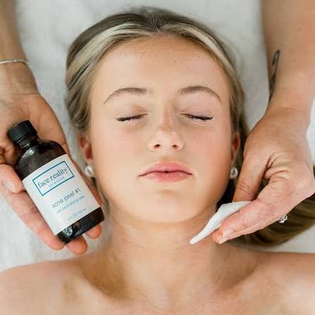 Face Reality facial treatment with a skincare product and cotton pad